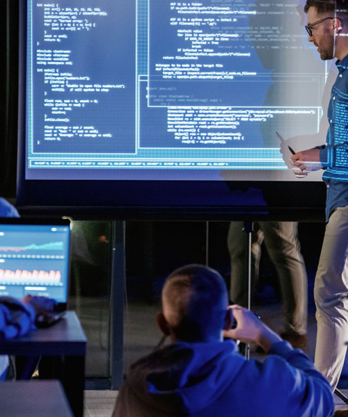 Teacher conducting university classes using computers with students