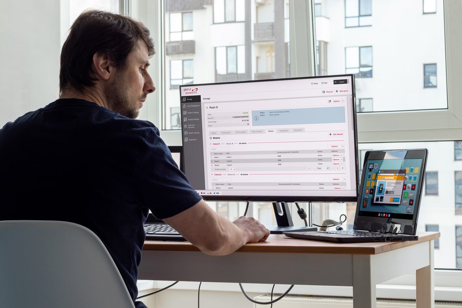 man sitting in front of a screen with Open-E JovanDSS GUI