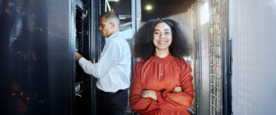 IT admin working by on server connections and happy girl standing in front