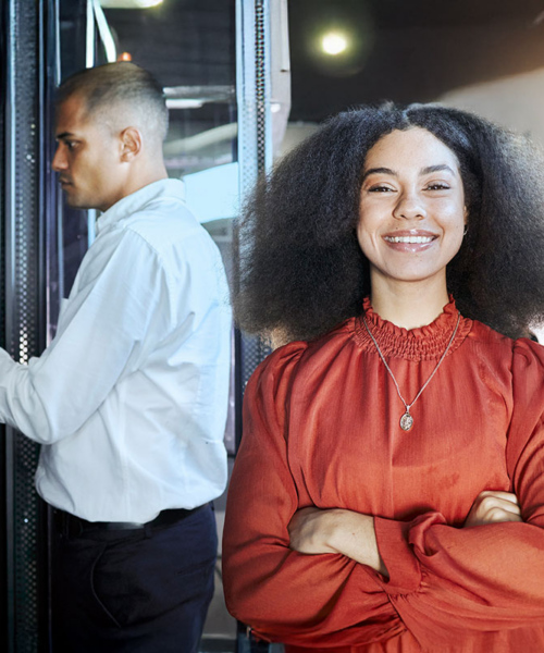 IT admin working by on server connections and happy girl standing in front