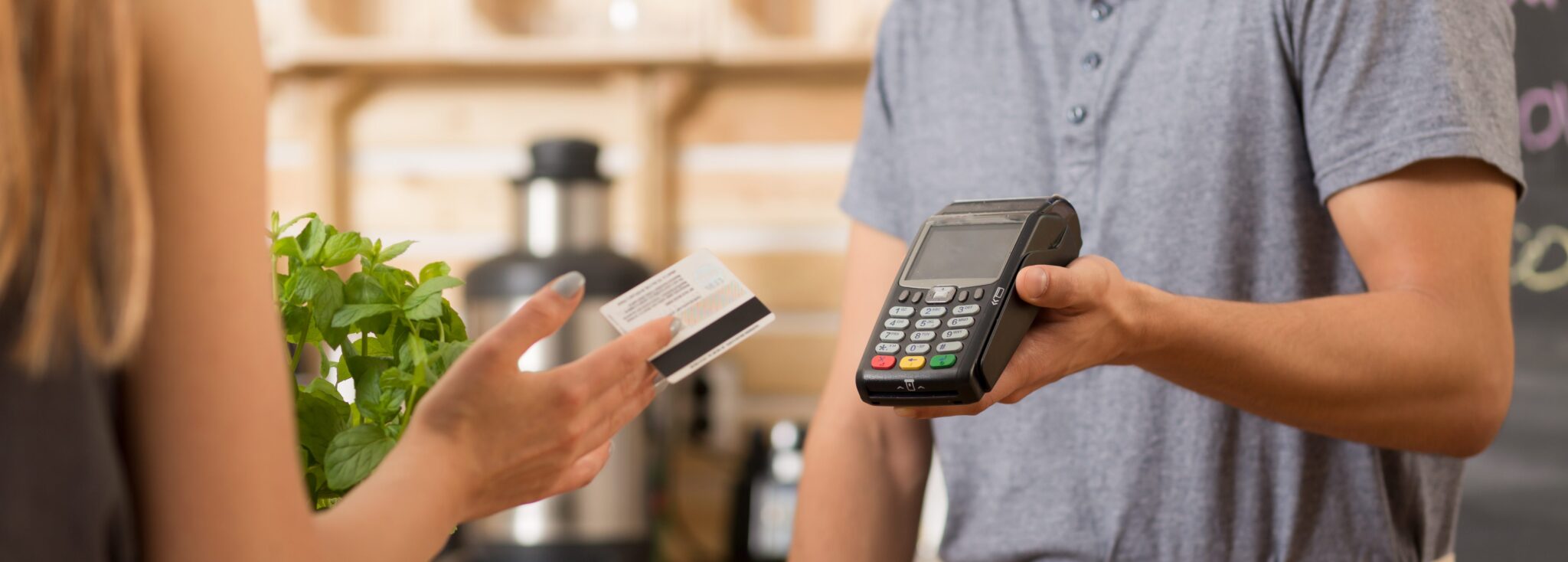 customer paying with card in a coffee shop