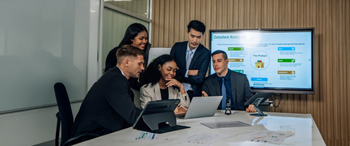 People at the meeting in the office happy about centralized data storage infrastructure results - Cover of the Open-E article