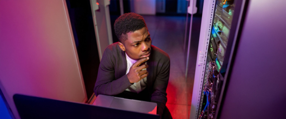 IT admin sitting in front of the server confused