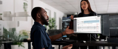 People in the office in front of computer waiting for a program update