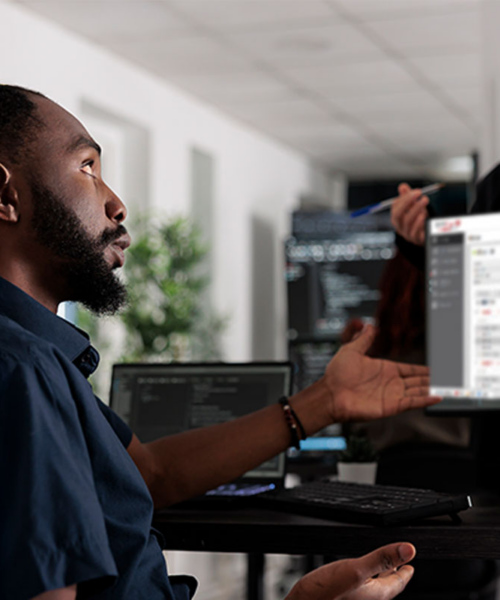 People in the office in front of computer waiting for a program update
