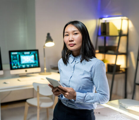 Data Storage Woman Administrator standing in a room with Open-E JovianDSS GUI displayed on desktop