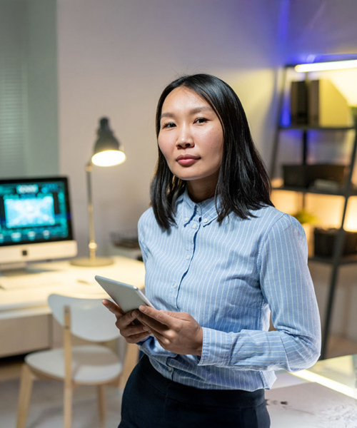 Data Storage Woman Administrator standing in a room with Open-E JovianDSS GUI displayed on desktop