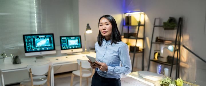 Data Storage Woman Administrator standing in a room with Open-E JovianDSS GUI displayed on desktop