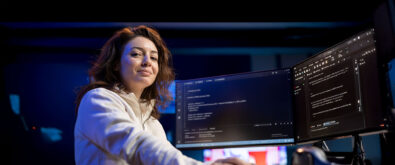 Women sitting in front of computer coding