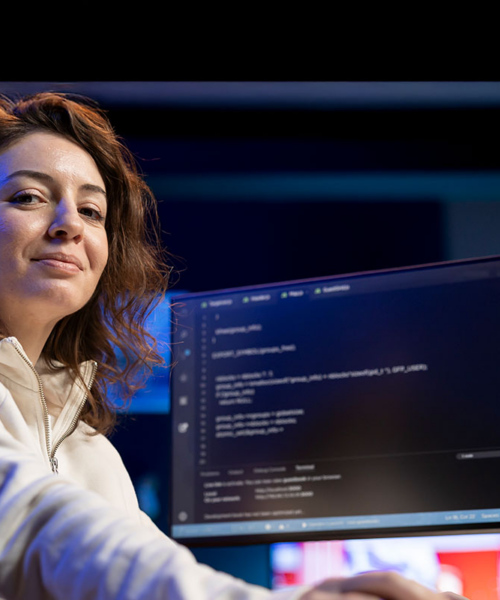 Women sitting in front of computer coding