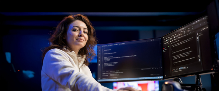 Women sitting in front of computer coding
