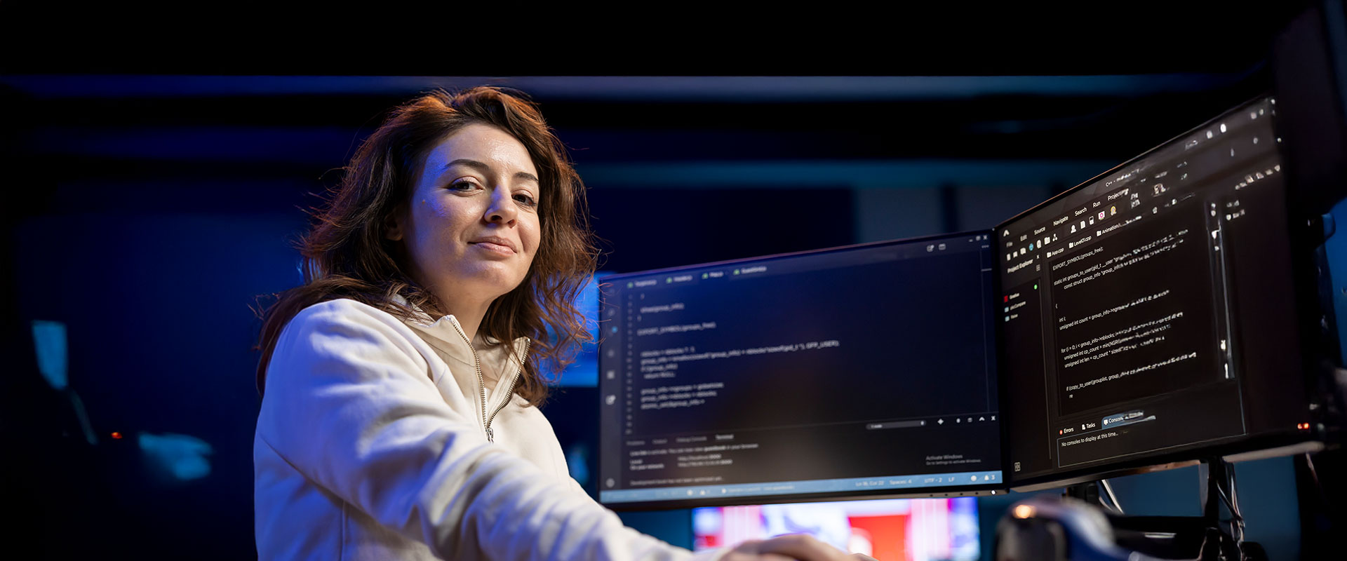 Women sitting in front of computer coding