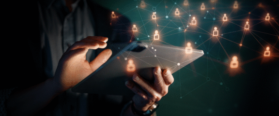 IT Administrator hands holding tablet; digital icons around