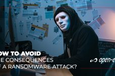 How To avoid Consequences of Ransomware Attack - hacker sitting in front of the computer looking at the camera
